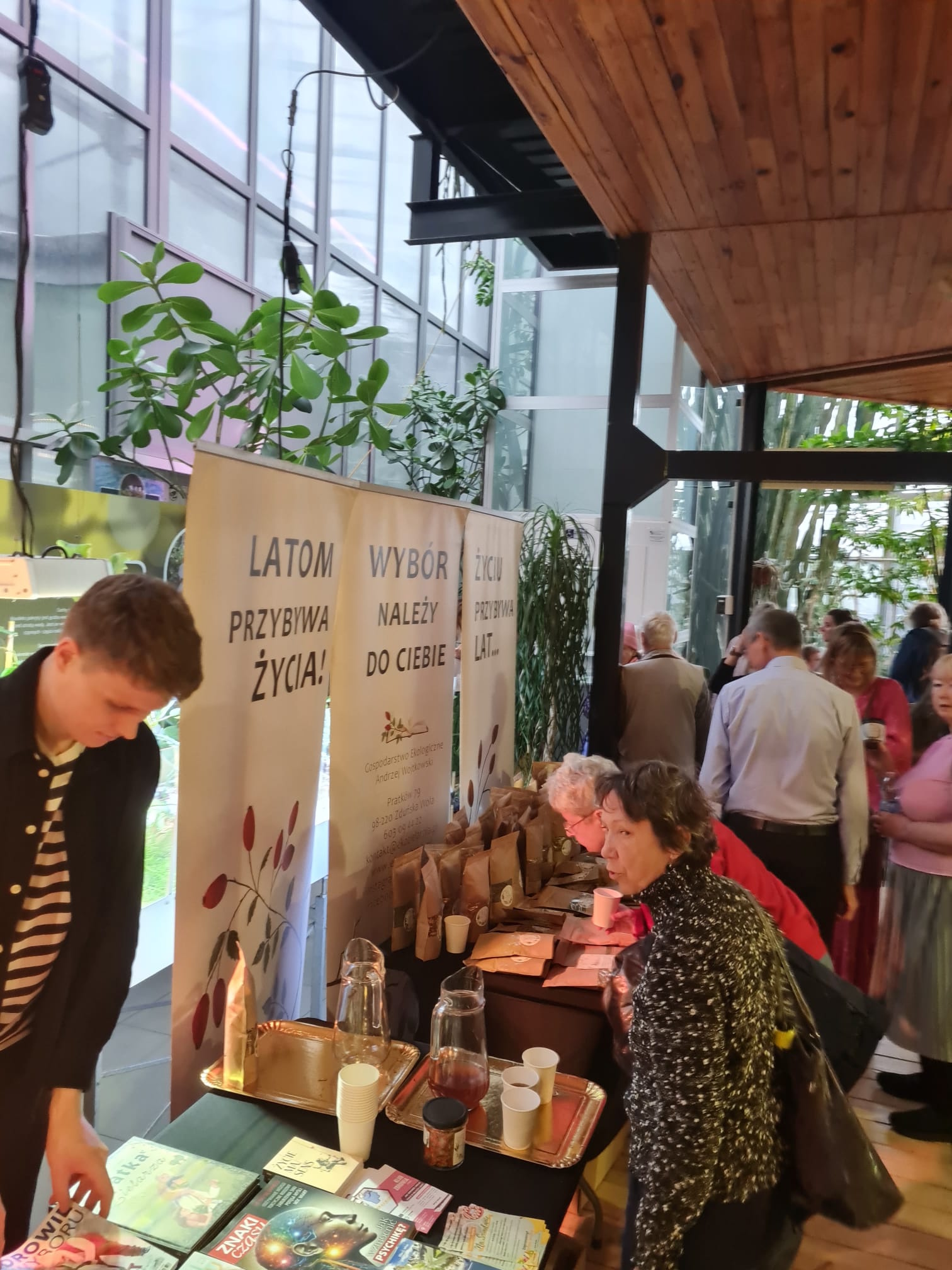 ludzie przy stoiskach w Palmiarni