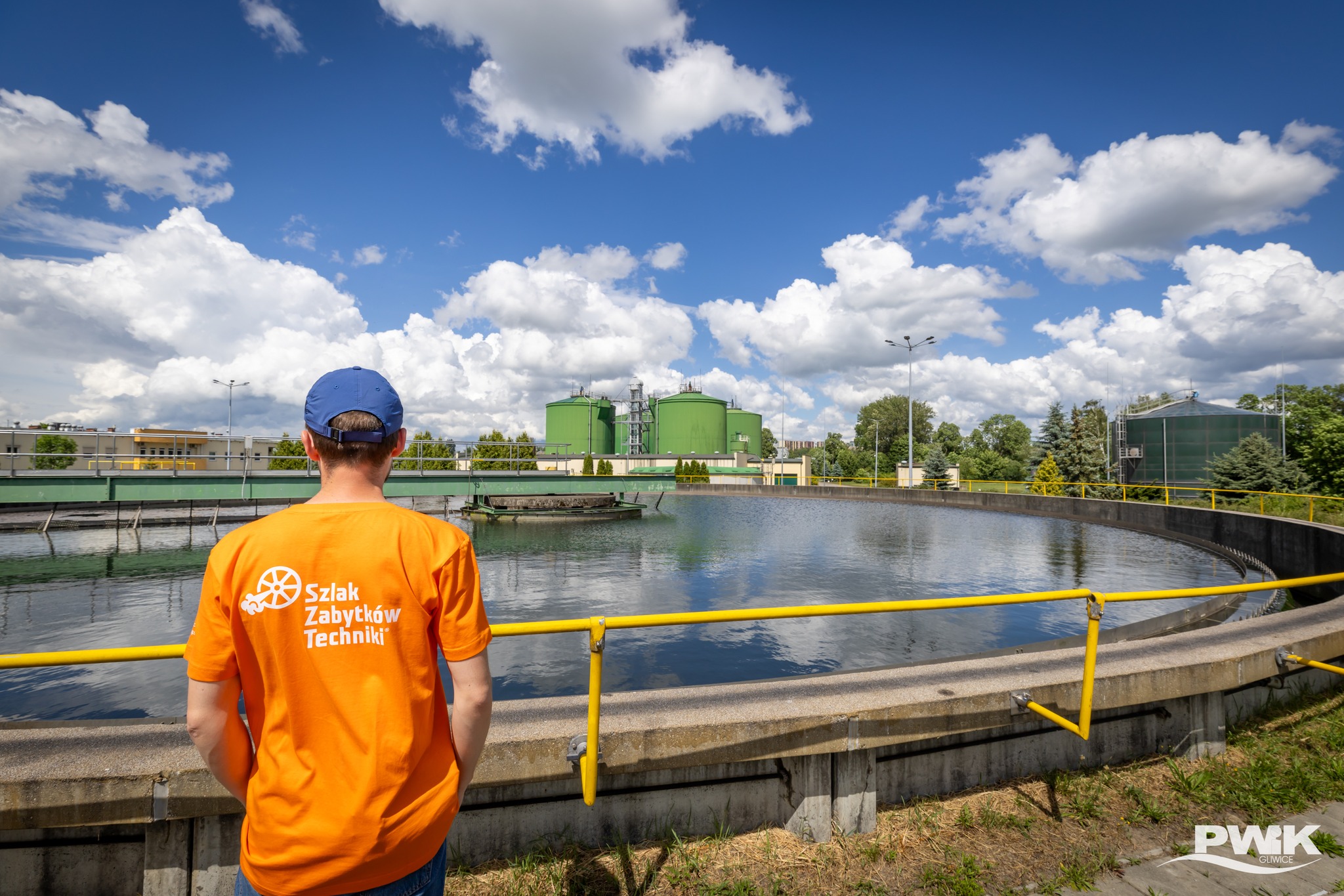 Fot. PWiK Pan w koszulce Industriady patrzący w stronę zbiornika w Centralnej Oczyszczalni Ścieków
