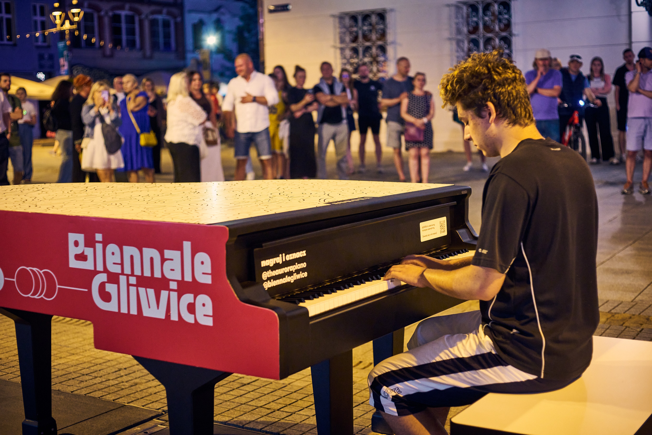 Chłopak grający na festiwalowym fortepianie na Rynku