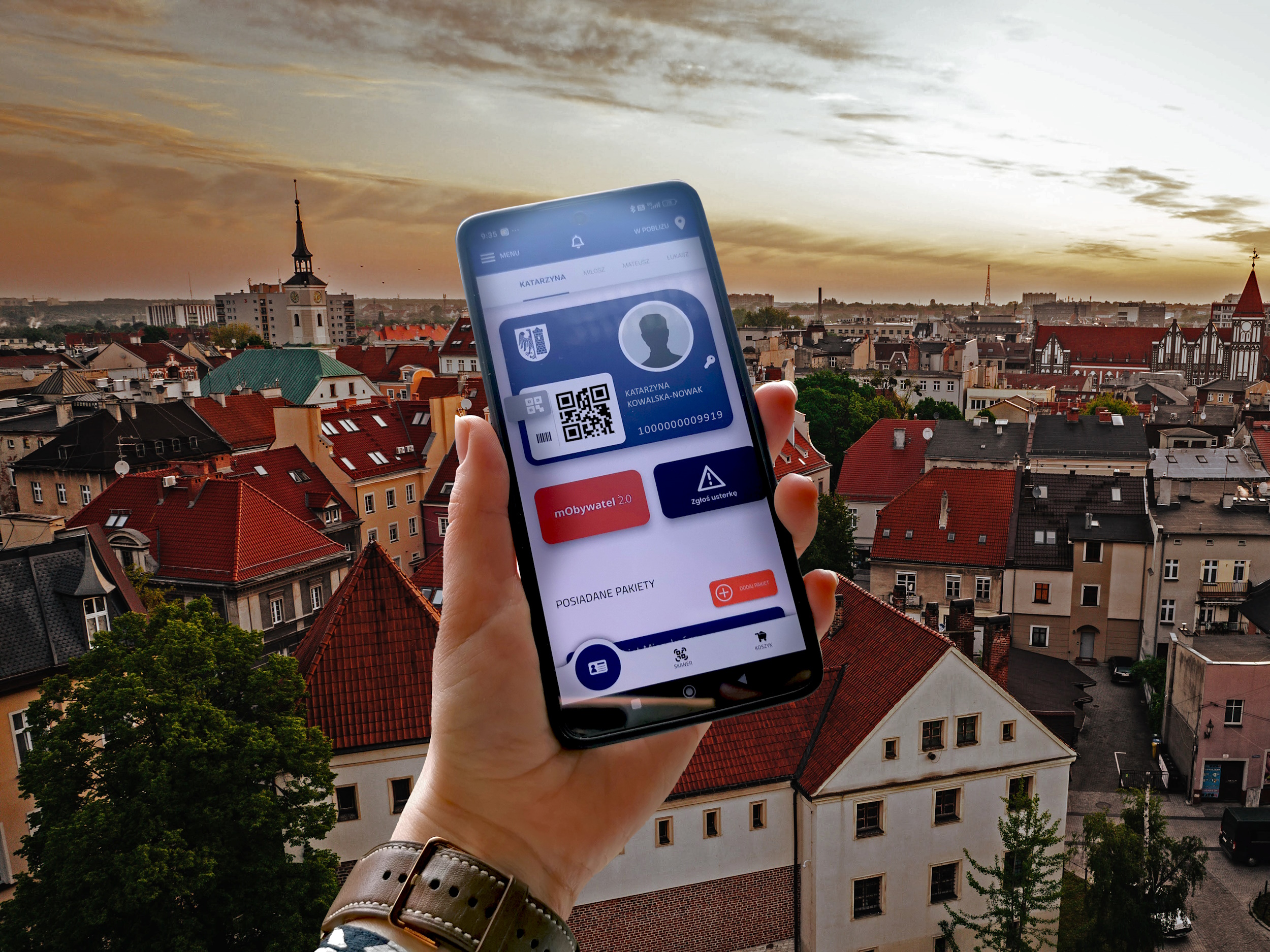 Dłoń trzymająca telefon z otwartą aplikacją Gliwickiej Karty Mieszkańca