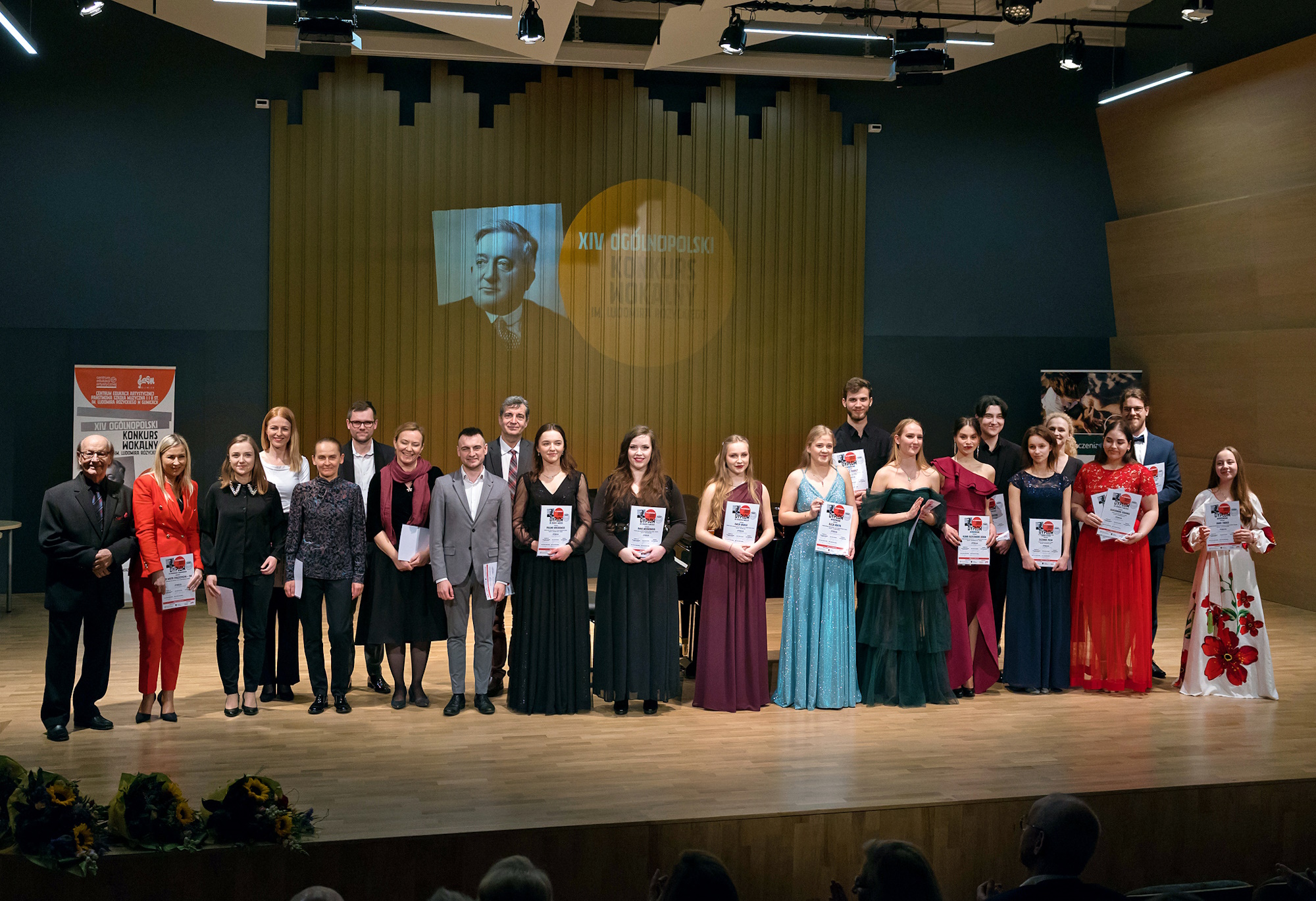 Laureaci konkursu w odświętnych strojach stoją na scenie